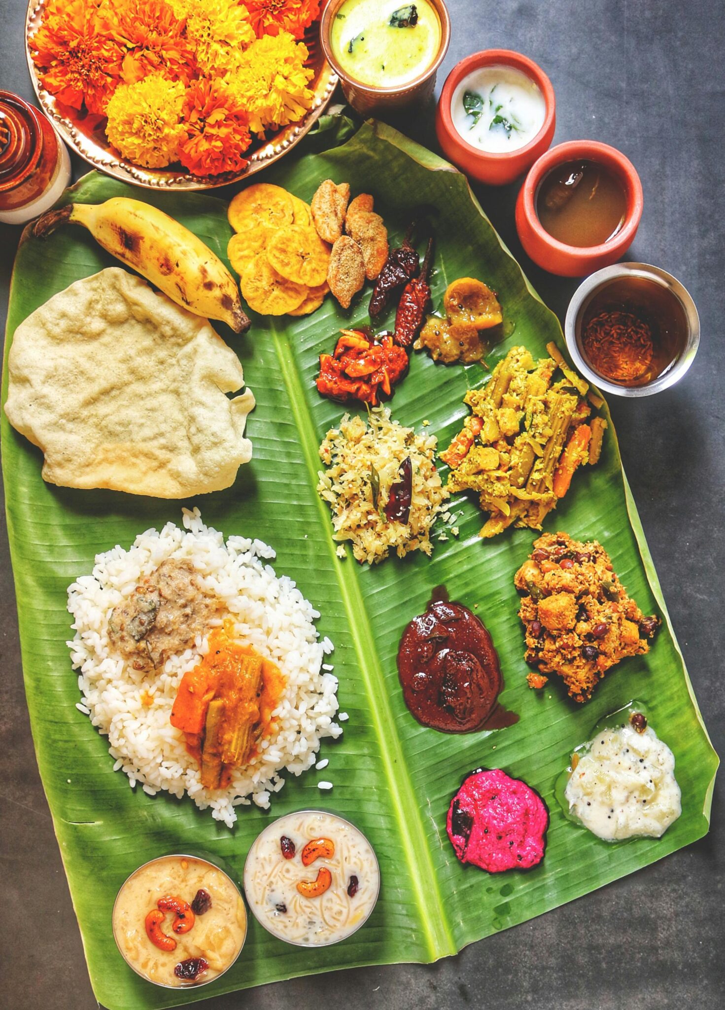A vibrant display of Kerala Sadya on banana leaf, featuring traditional Onam dishes.